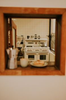 A glimpse into a charming vintage kitchen featuring a retro stove and coffee setup.