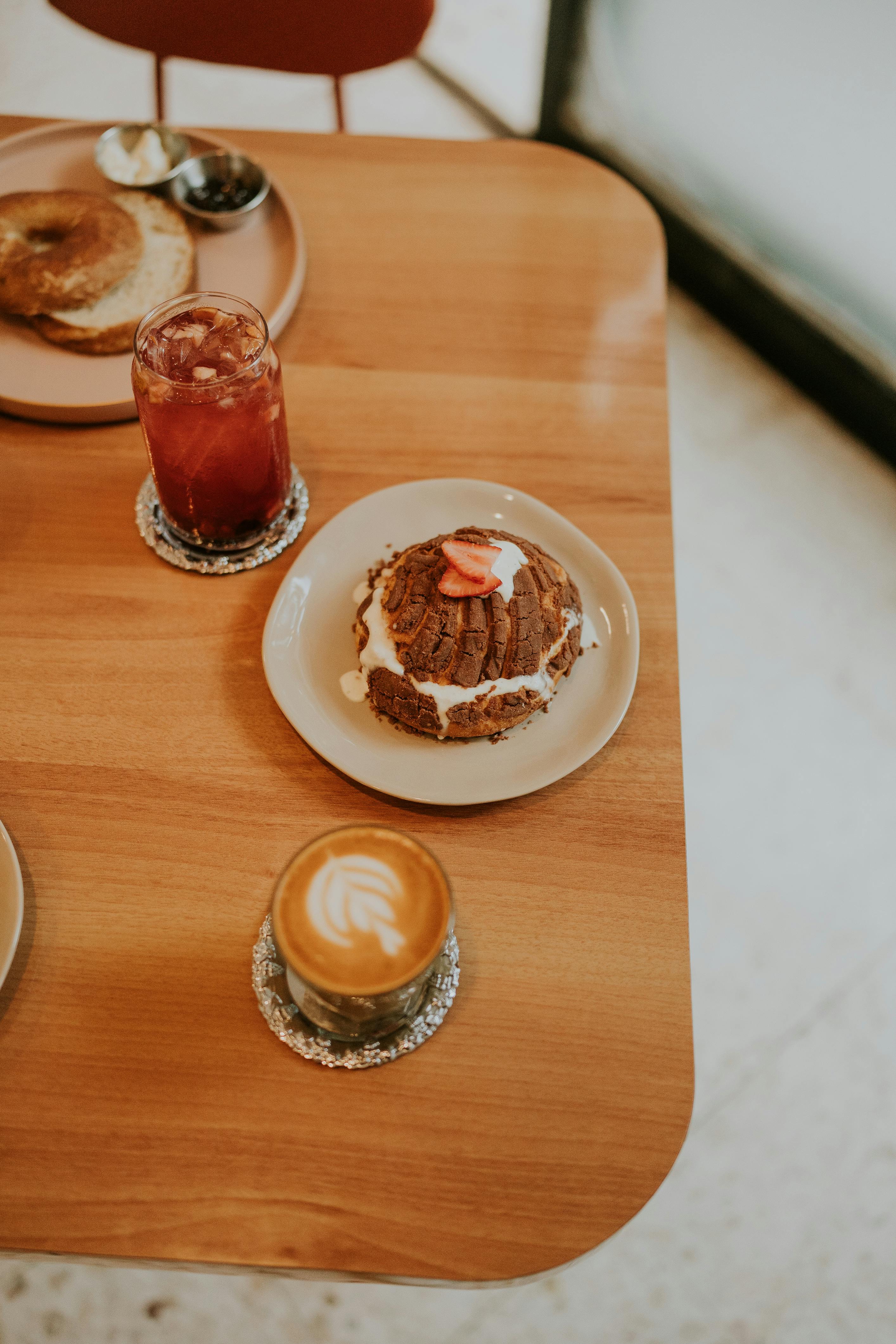 A table with two plates of food and drinks