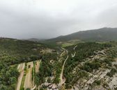 Breathtaking aerial view of Manzanares el Real showcasing lush hills and winding roads.