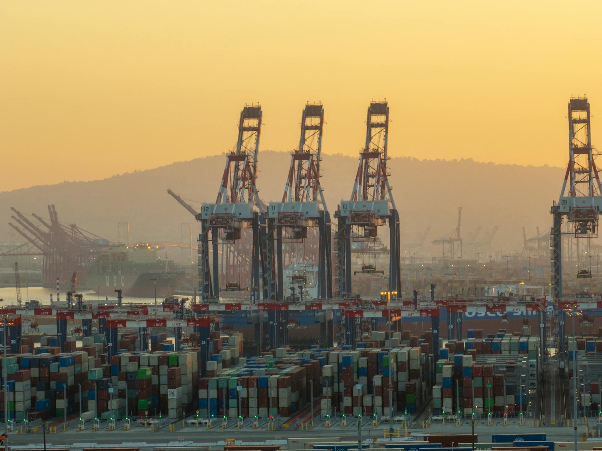 A large container ship is docked at a port