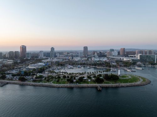 Free Stunning aerial view of Long Beach, CA skyline with harbor at dusk. Stock Photo