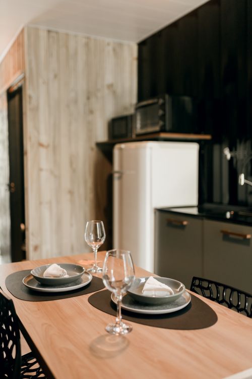 Free Contemporary dining setting with stylish tableware in a modern indoor kitchen. Stock Photo