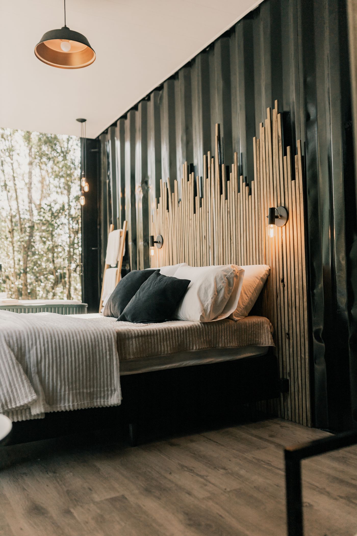 Bedroom with timber wall and forest view