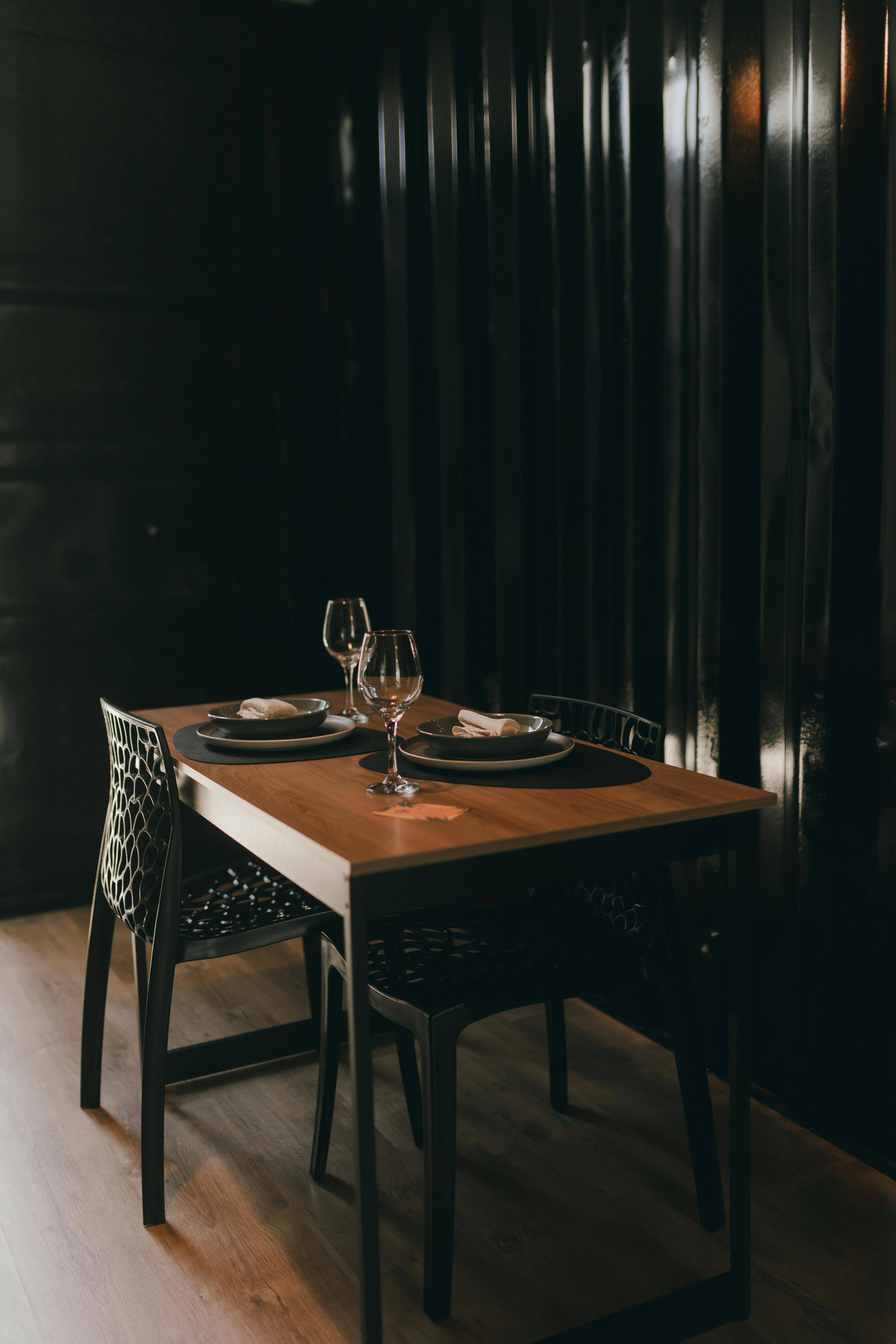 A table with two empty wine glasses and a plate