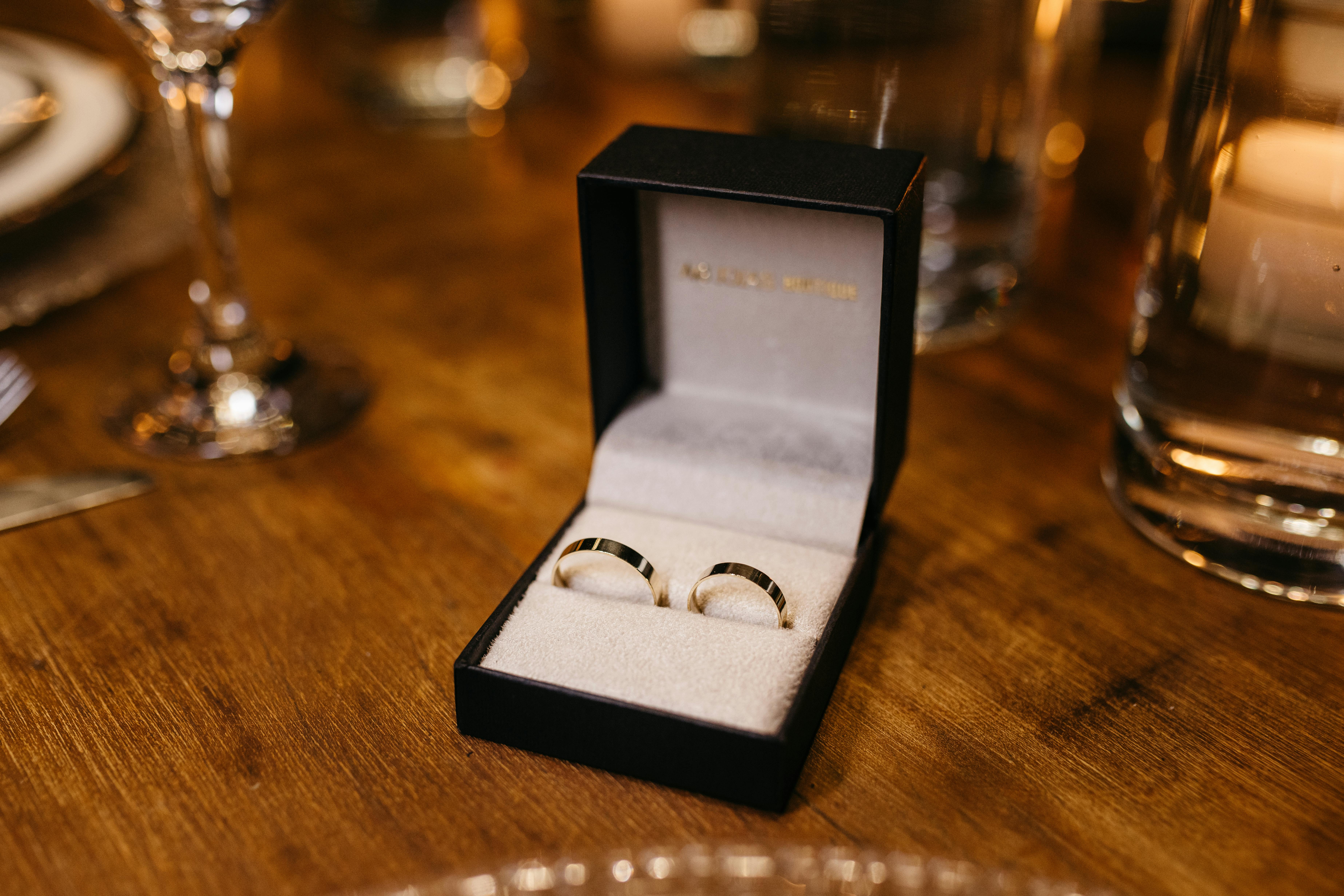 box with wedding rings on wooden table