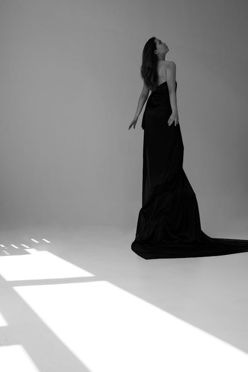 Grayscale Photography of Woman Wearing Long Train Gown