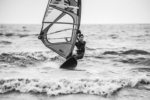 Grayscale Photo of Man Surfing