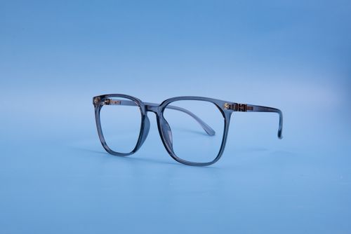 Free Classic eyeglasses on a blue background with minimalistic style. Stock Photo