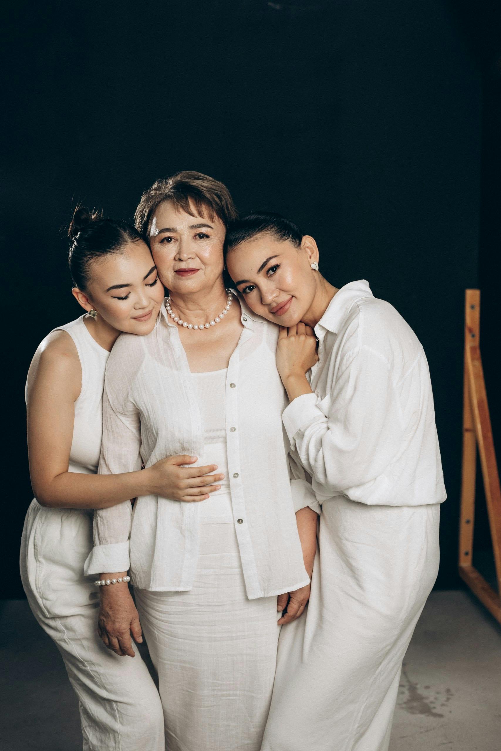 three women posing together in a studio