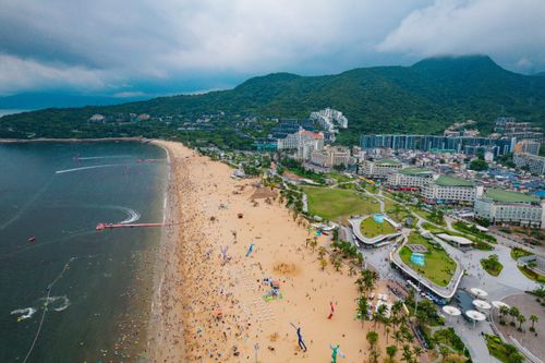 Free Discover the vibrant beachfront and lush hills of Shenzhen, China from above. Stock Photo