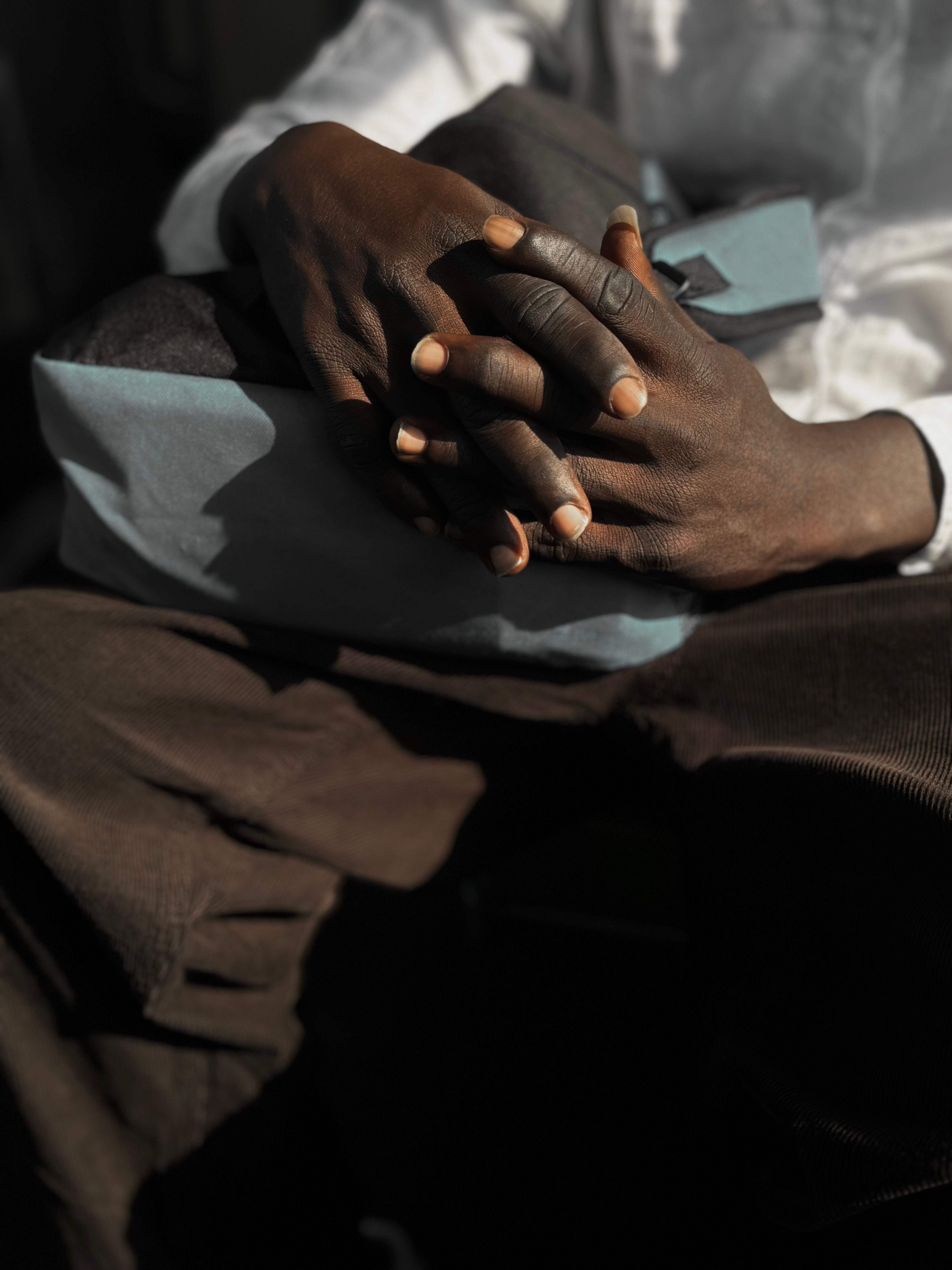 A person with their hands on their lap · Free Stock Photo