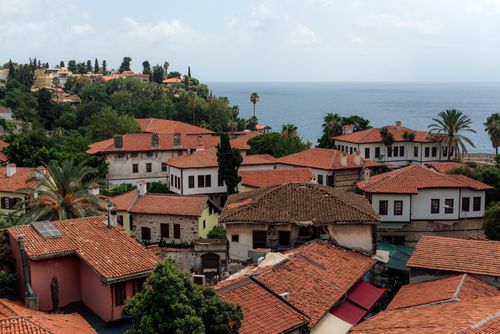 Free Charming view of Antalya's historic rooftops with the Mediterranean Sea in the background. Stock Photo