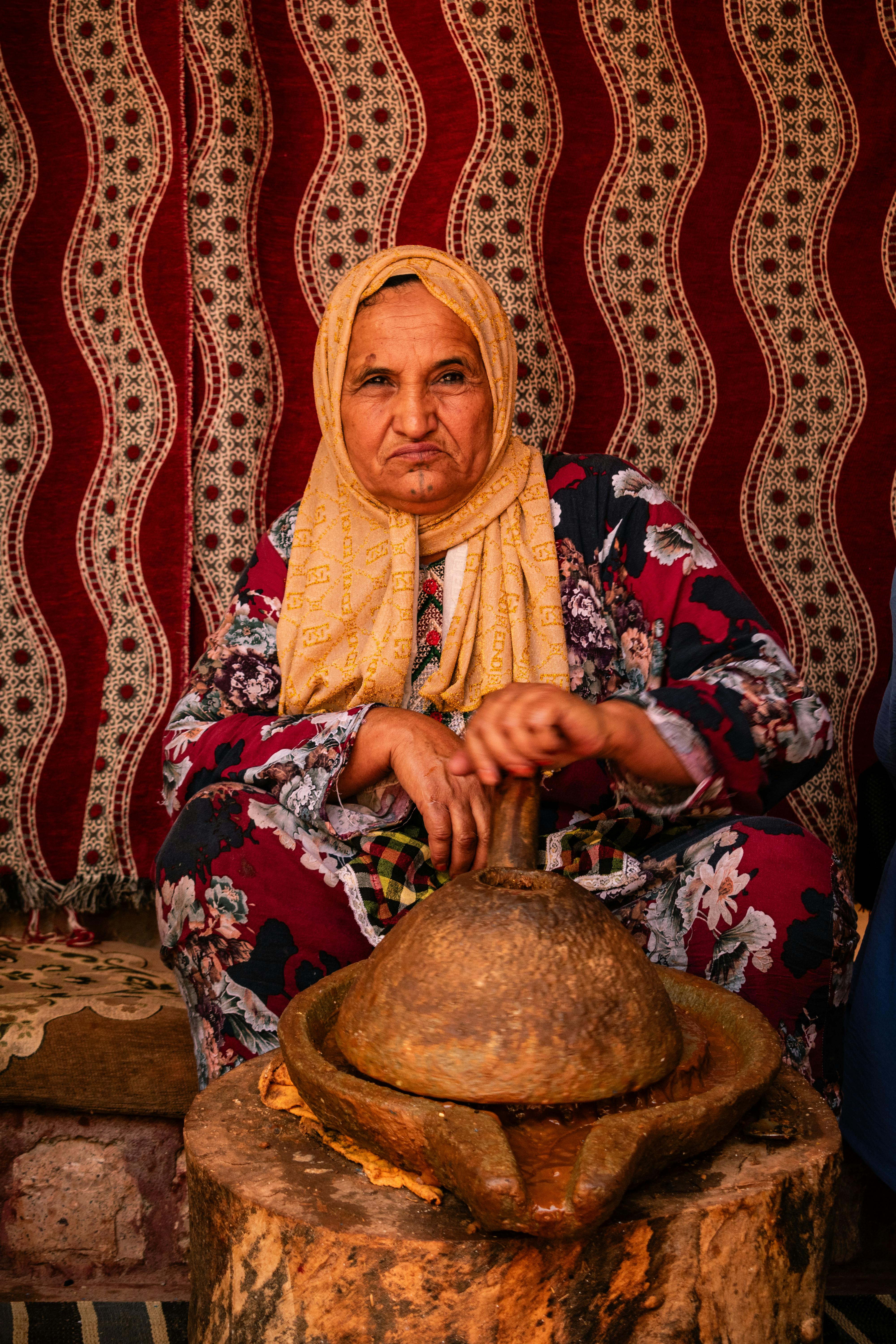 elderly woman sitting in traditional clothing