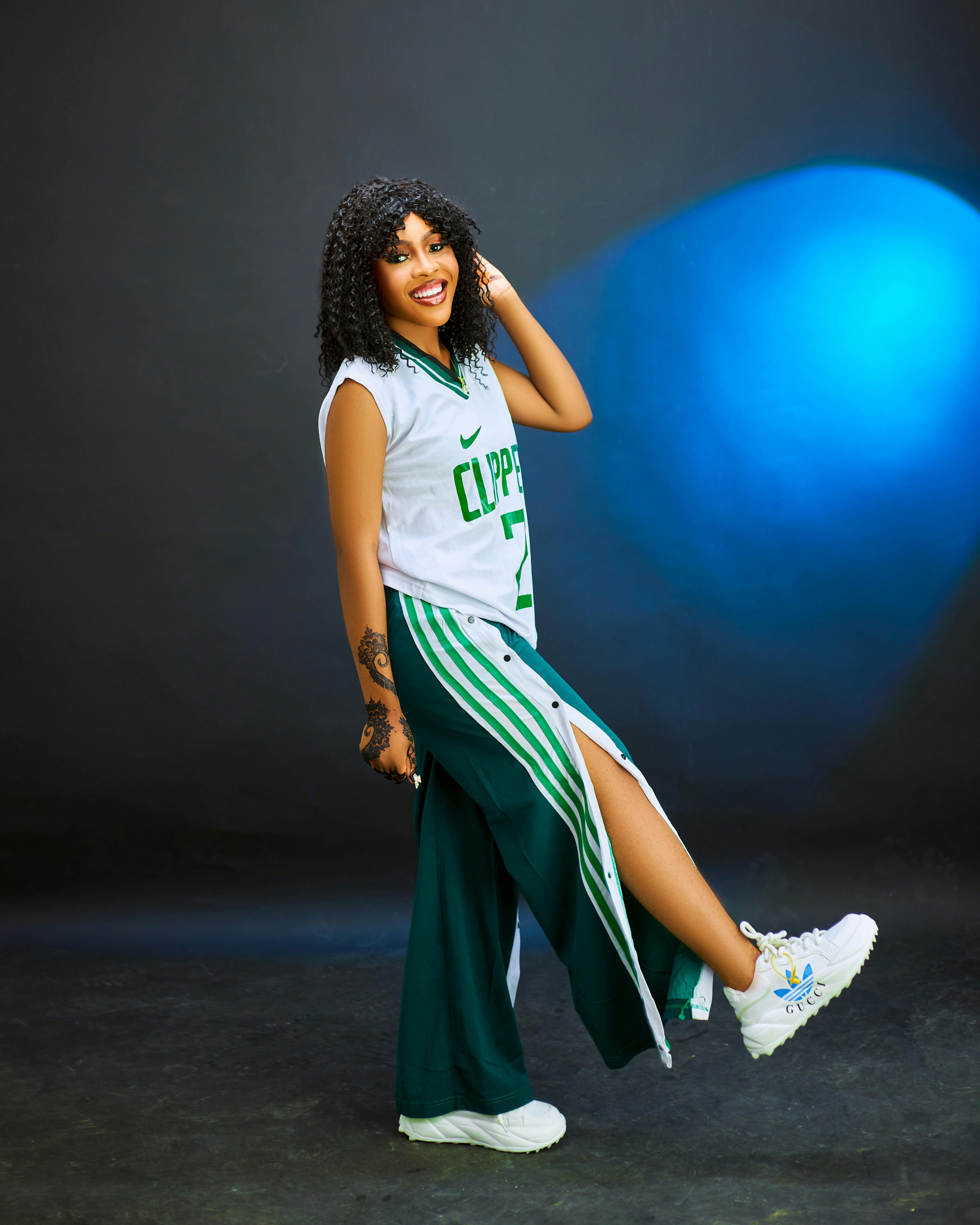 a woman in a green and white jersey and pants