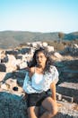 Photo of a Woman Sitting on Concrete Block