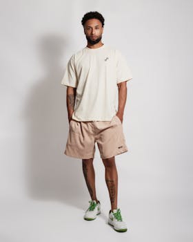 Young man modeling casual summer fashion with style and confidence.