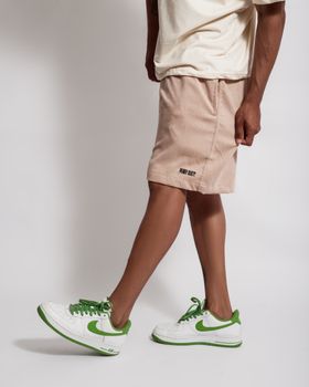 Stylish young adult in casual streetwear and sneakers, showcasing modern fashion trends.
