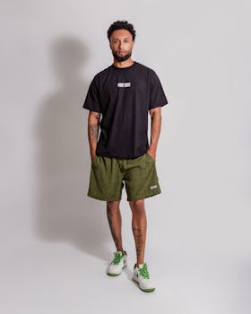 Full-length portrait of a man in trendy casual wear and sneakers.