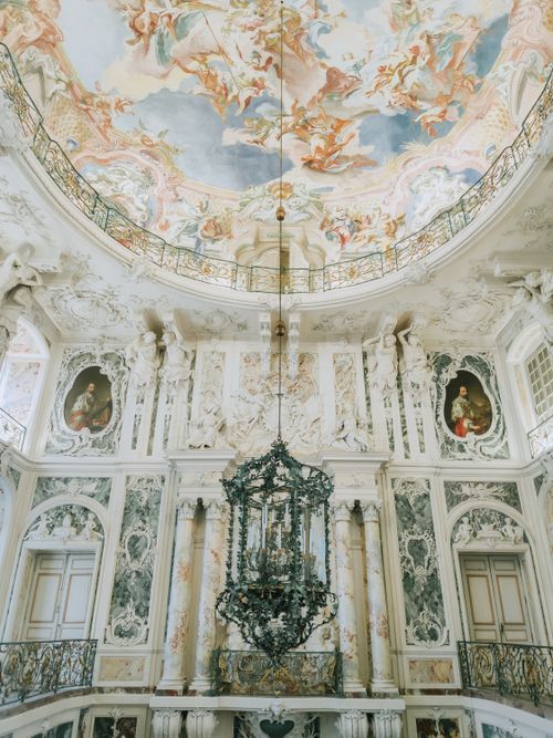 Free Stunning Baroque church interior featuring intricate frescoes and grand chandelier. Stock Photo