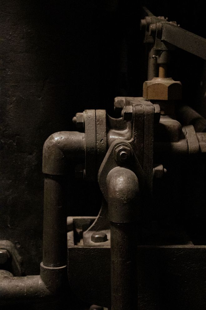 Close-up of vintage industrial pipes in moody light. Photo by Sueda Gln on Pexels.