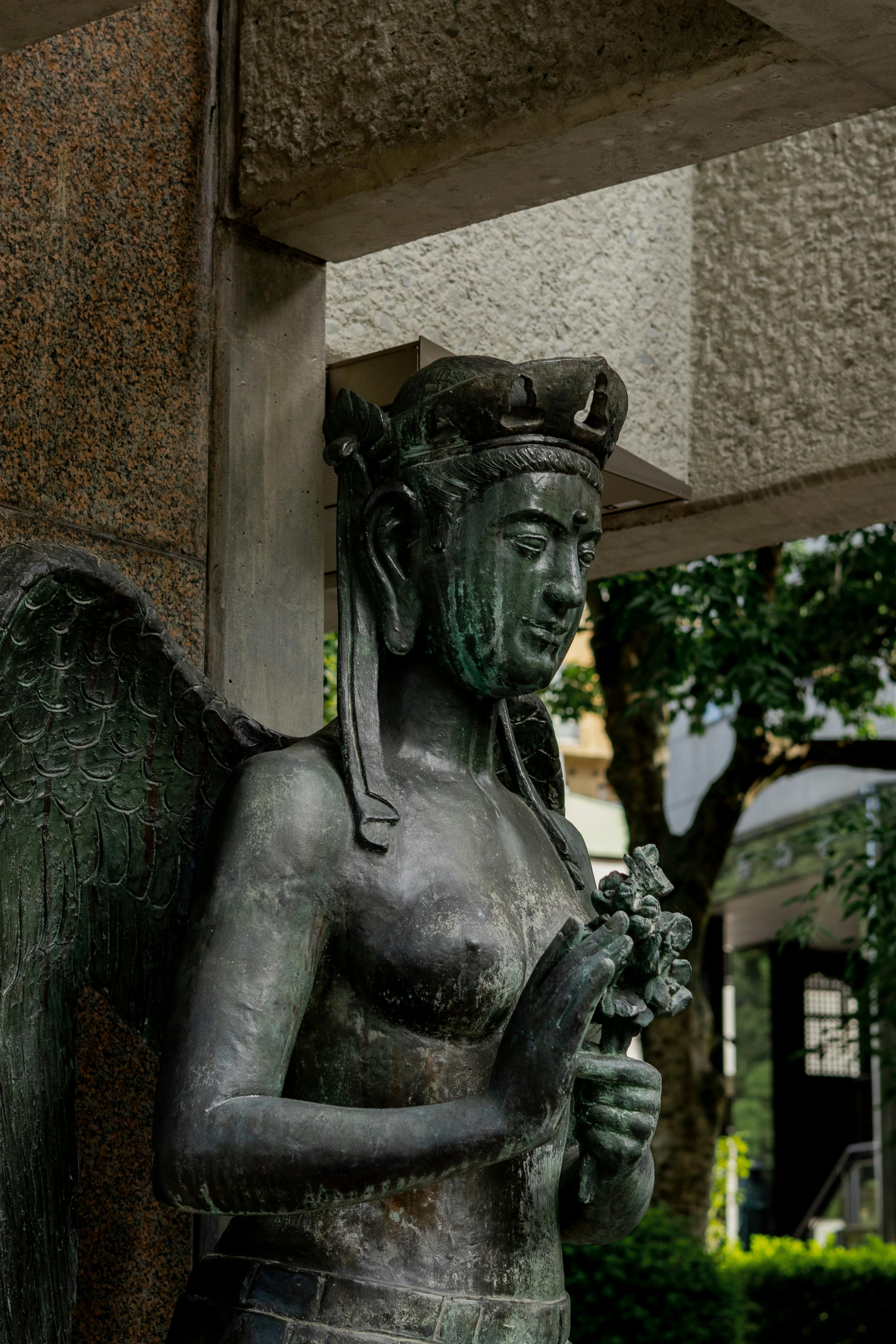 a statue of an angel holding a flower