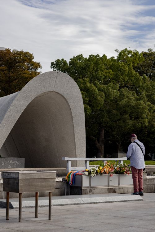 Free A solemn moment captured at Hiroshima Peace Memorial with a person paying respects. Stock Photo