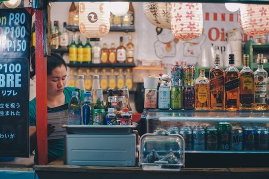 Colorful street bar in Cebu City, Philippines, showcasing a variety of alcohol and beverages.