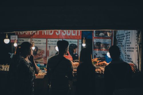 Free A vibrant night street food market in Cebu City with people enjoying Asian cuisine. Stock Photo