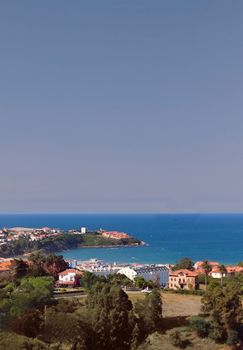 Captivating coastal view of Suances, Spain, showcasing vibrant blue waters and charming architecture.