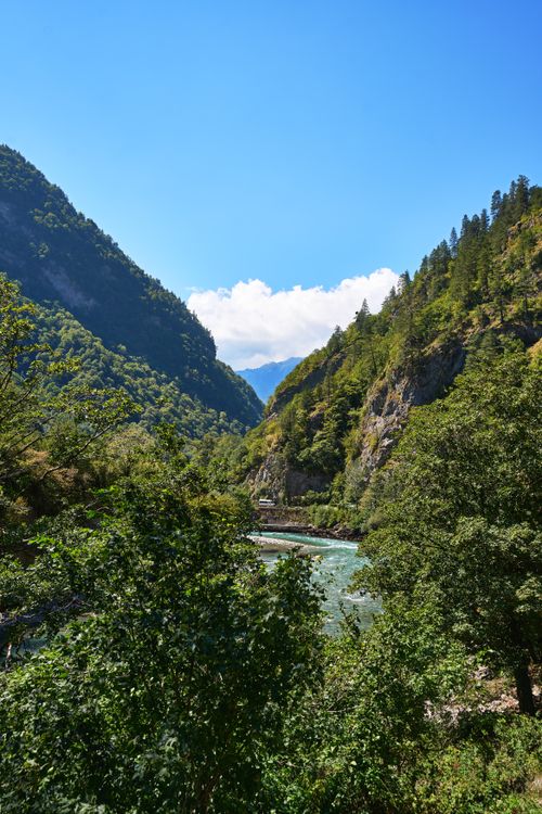 Free Vibrant summer view of a mountain river flowing through a lush green valley. Stock Photo