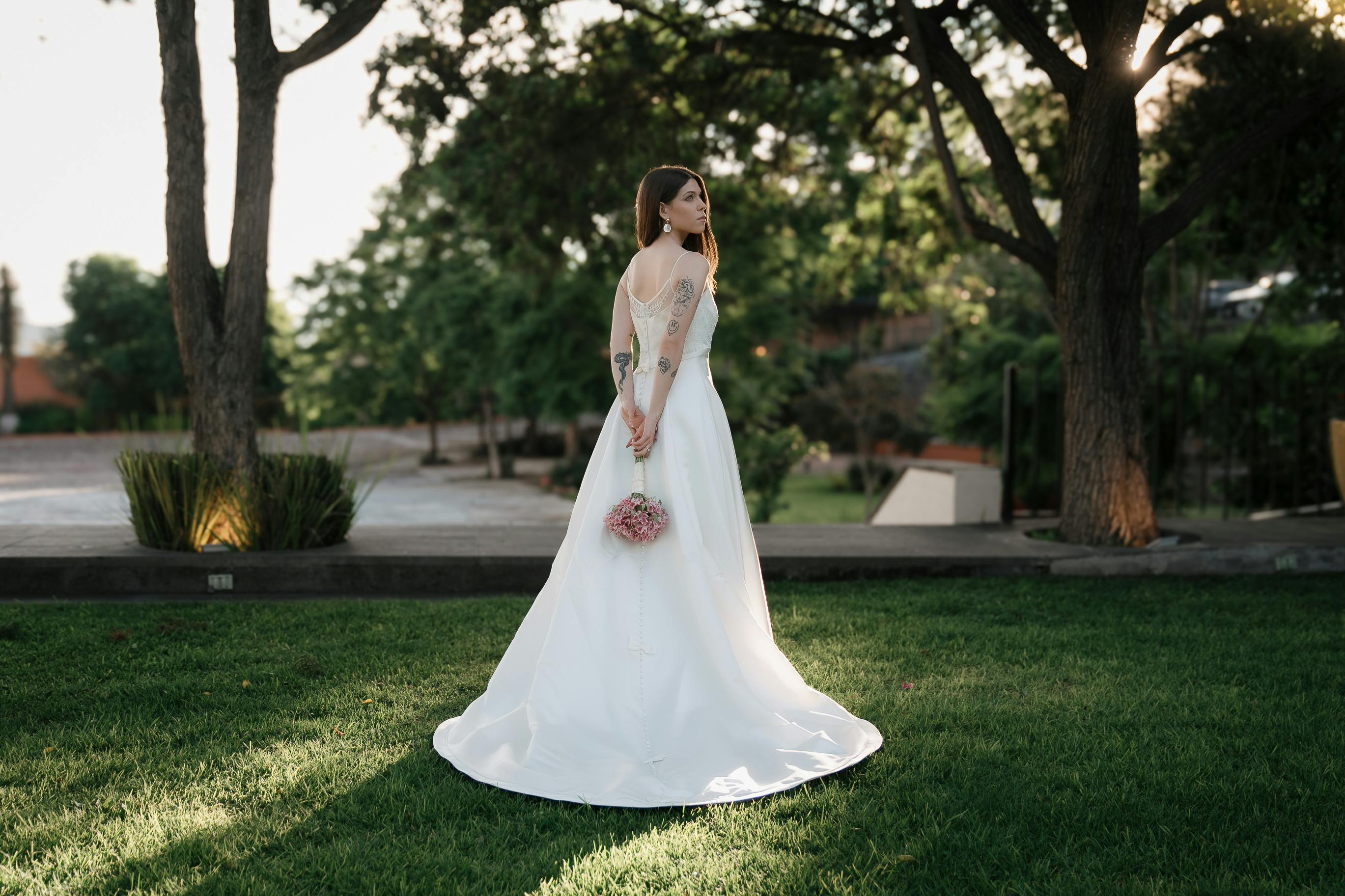 bride in wedding dress at park