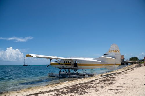 Free Seaplane on a sunny beach in Key West, Florida; perfect travel and leisure scene. Stock Photo