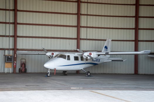A small white airplane parked inside an aircraft hangar in Key West, Florida.