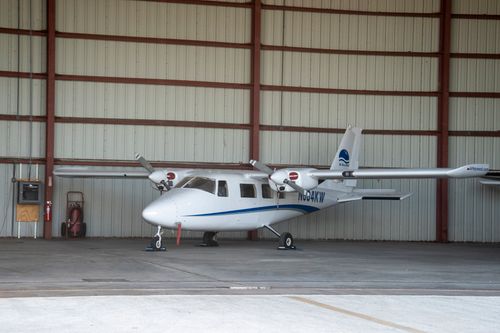 Free A small white airplane parked inside an aircraft hangar in Key West, Florida. Stock Photo