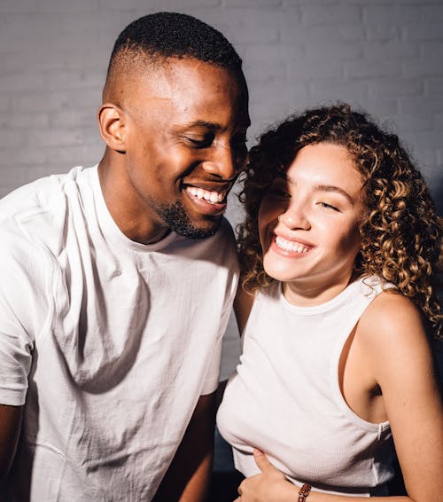 Photo of Man and Woman Smiling Next to Each Other