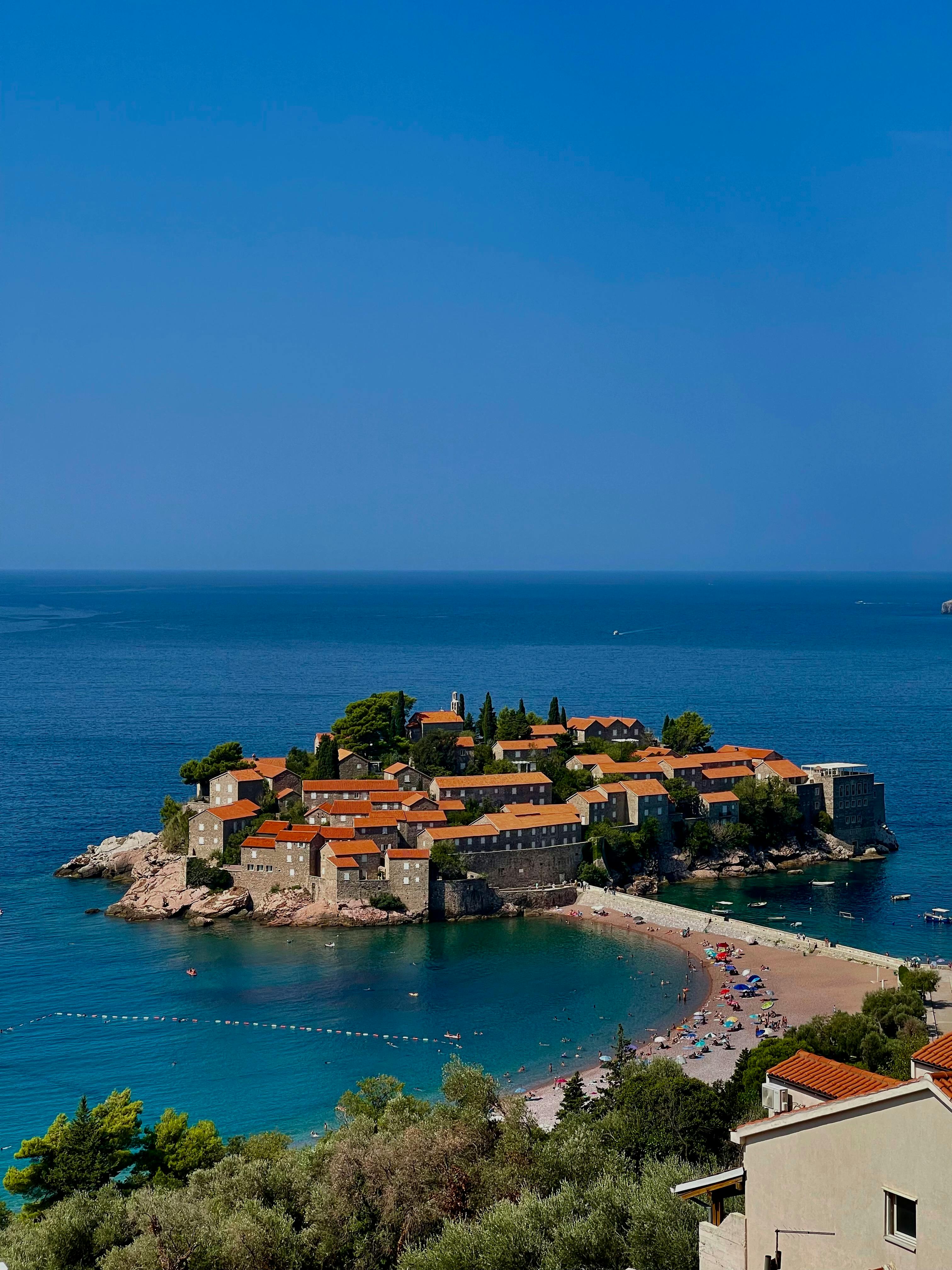 Stunning aerial photo of Sveti Stefan, Montenegro, showcasing its iconic architecture and crystal-clear waters.