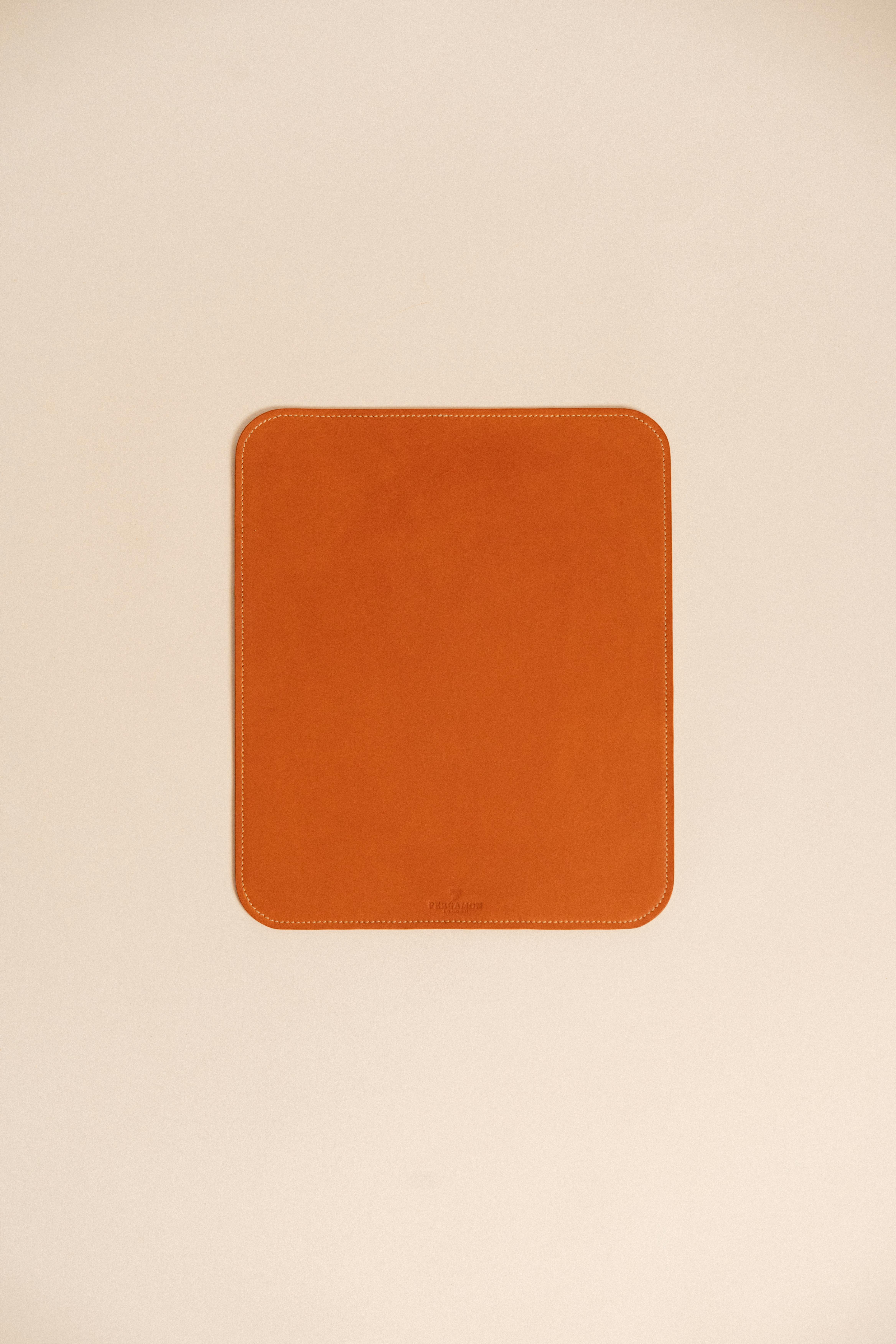 Free A stylish brown leather desk mat on a minimalistic beige surface, perfect for modern office spaces. Stock Photo
