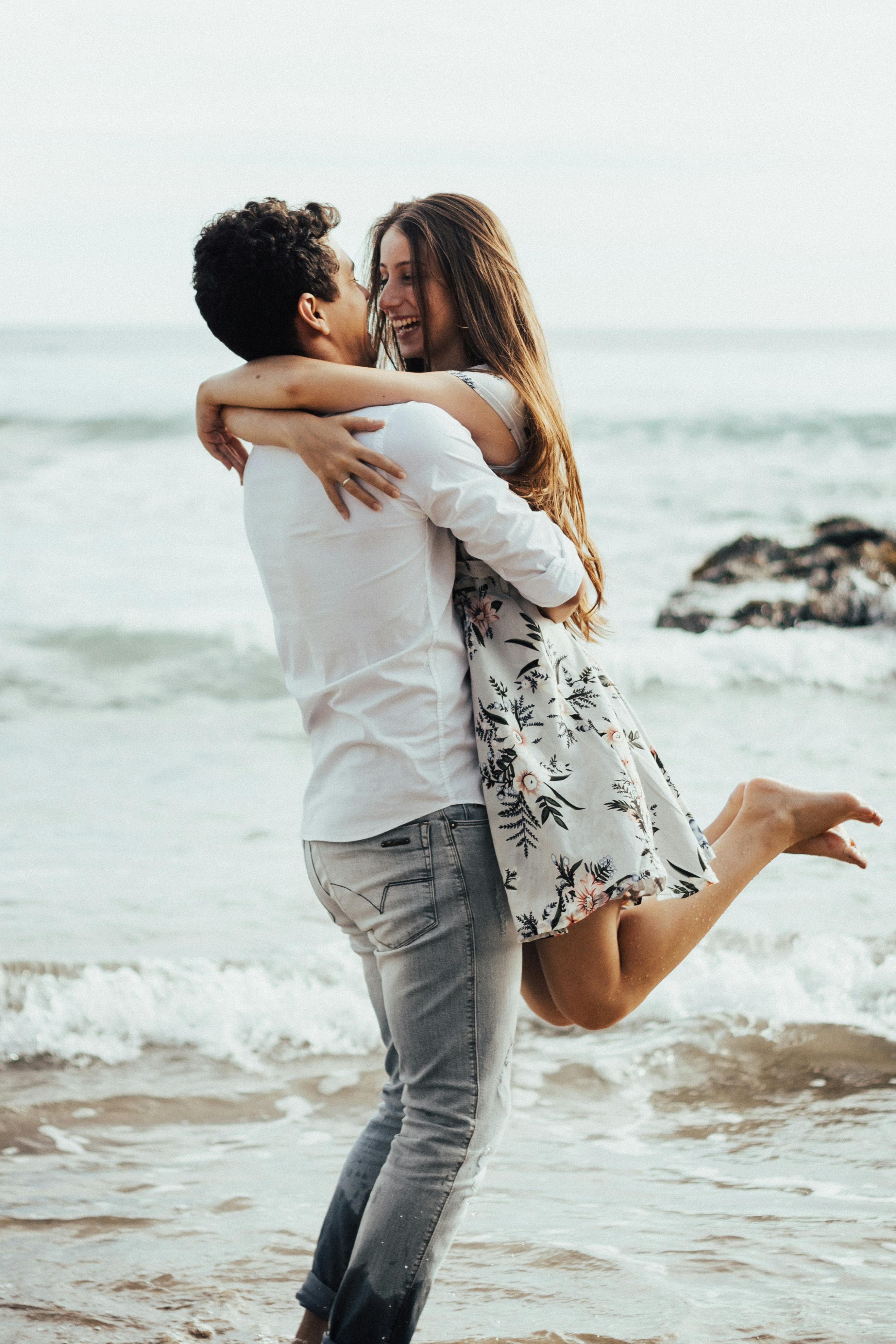 Couple in love posing at stone beach Stock Photo by ©AnnHaritonenko 75376699