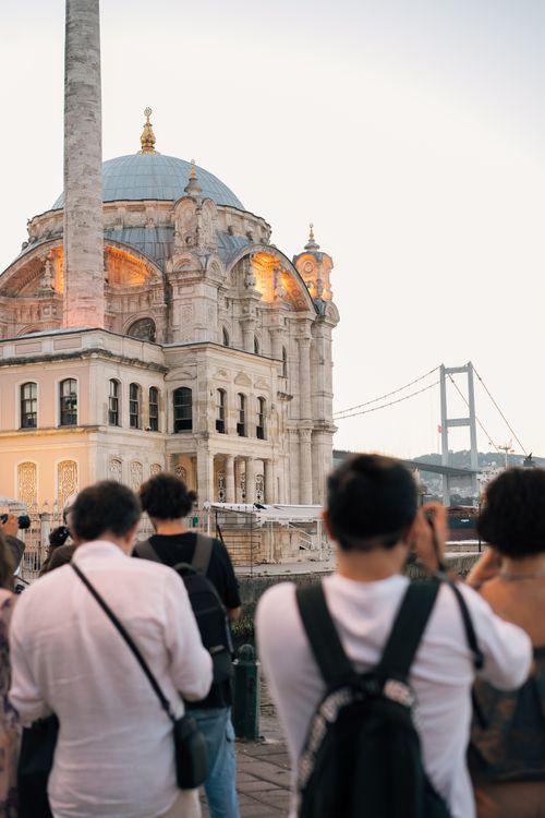 Free People photographing the stunning architecture of Ortaköy Mosque in Istanbul, Türkiye, with the Bosphorus Bridge in the background. Stock Photo