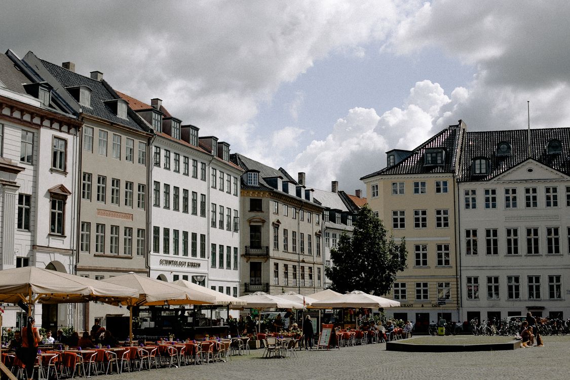 European square in Copenhagen with outdoor cafés, people and distinctive architecture