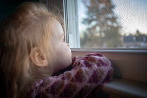 A Girl Looking Outside the Window