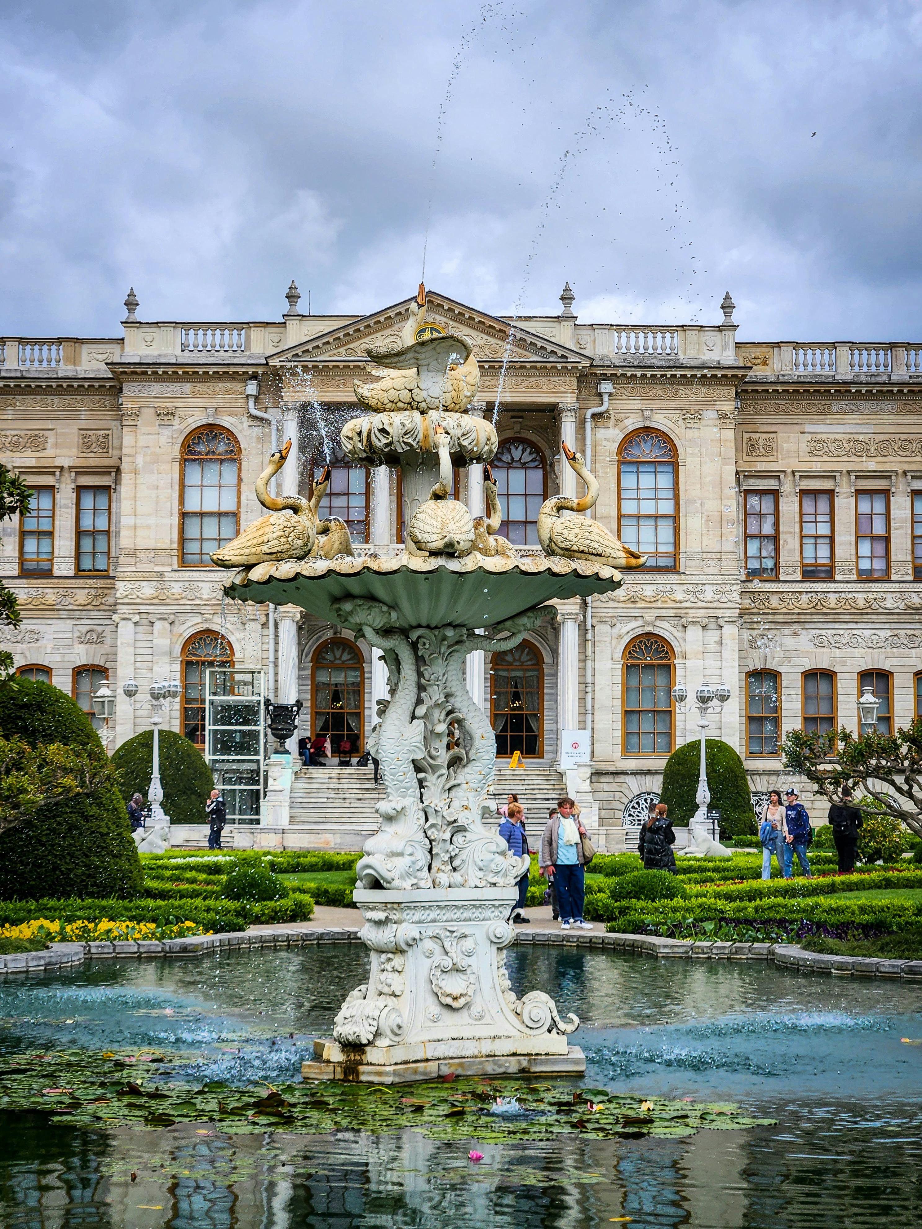 the fountain in front of a large building with a fountain