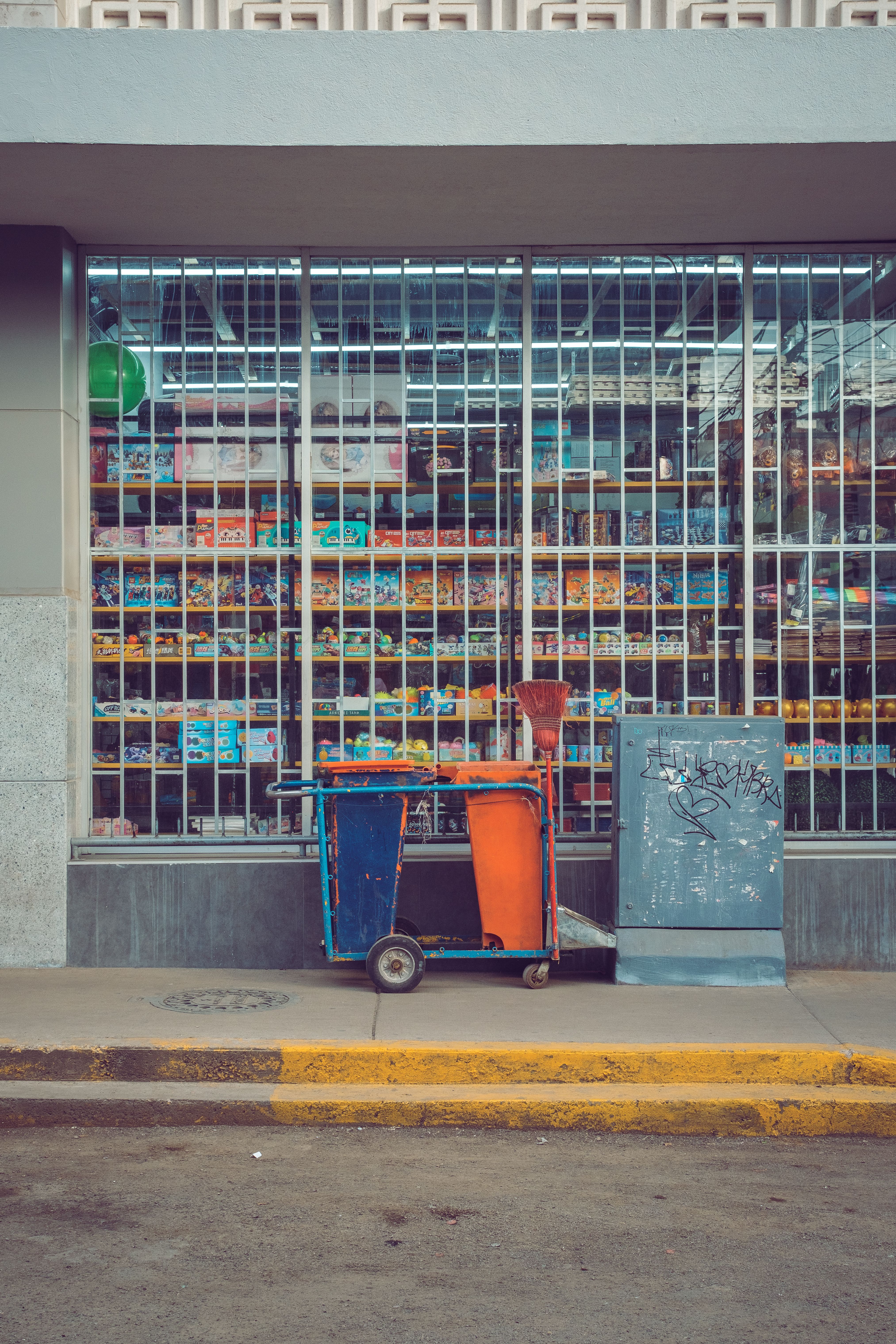 A trash can sitting in front of a store · Free Stock Photo