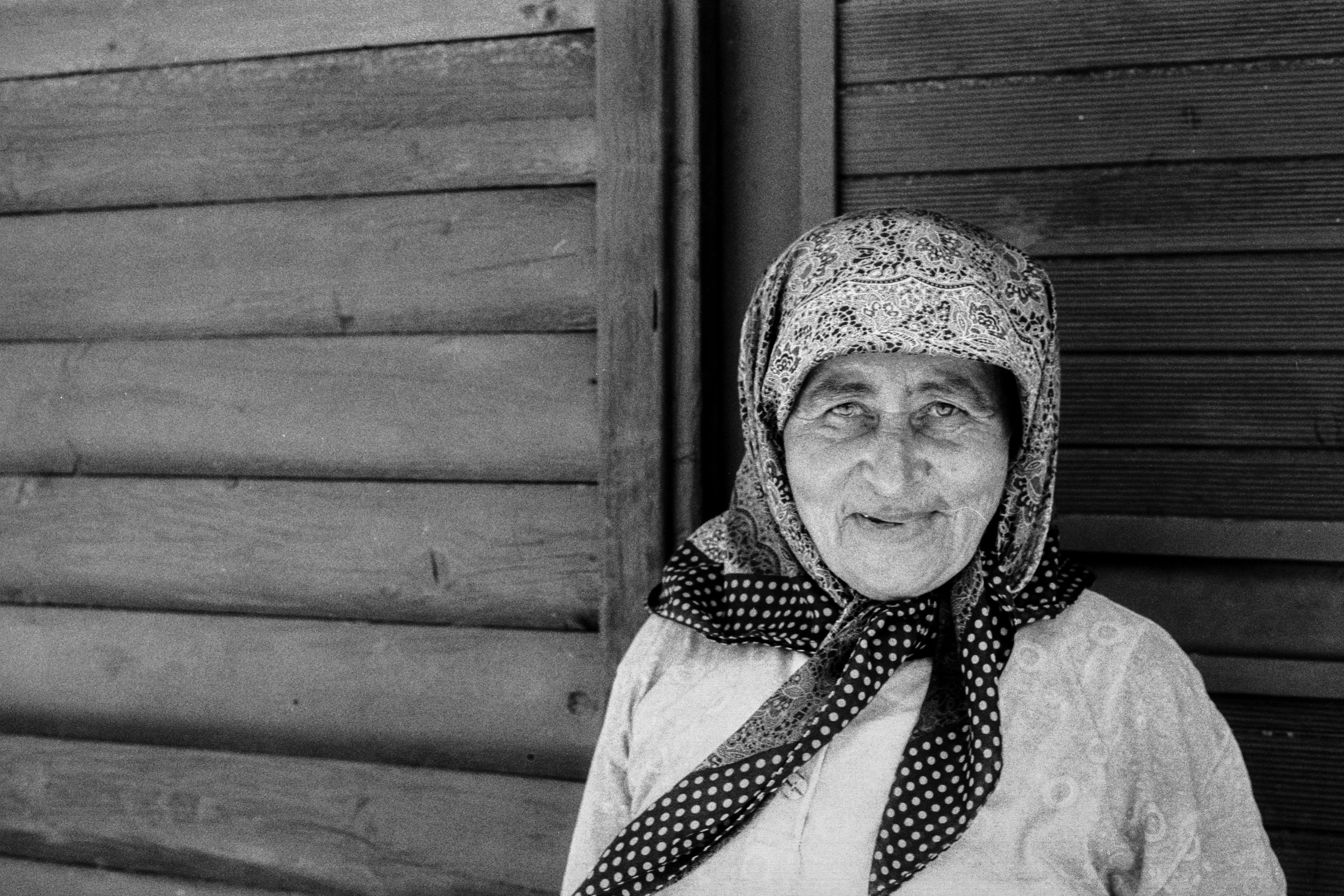 an old woman in a head scarf and scarf