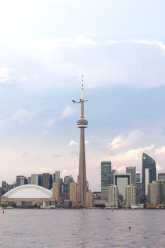 Breathtaking view of Toronto's skyline with CN Tower and a plane, capturing urban elegance.