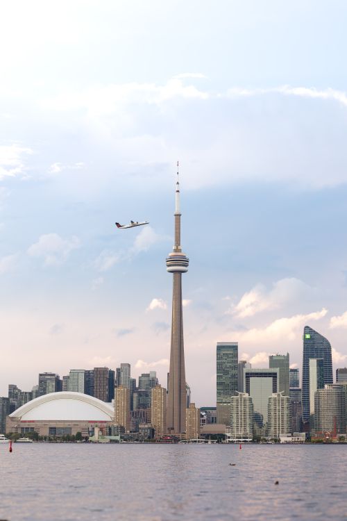 Free Stunning view of Toronto skyline at dusk with CN Tower and cityscape reflecting vibrant evening sky. Stock Photo