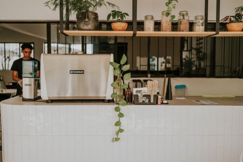 Free Contemporary café with a Rancilio espresso machine and modern interior design elements. Stock Photo