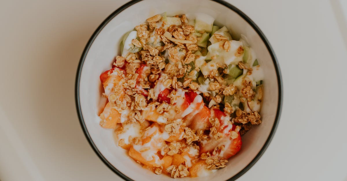 Top view of a delicious granola and fruit bowl with yogurt, perfect for a healthy breakfast.