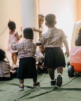 A group of young children enjoying playtime at school, dressed in uniforms.