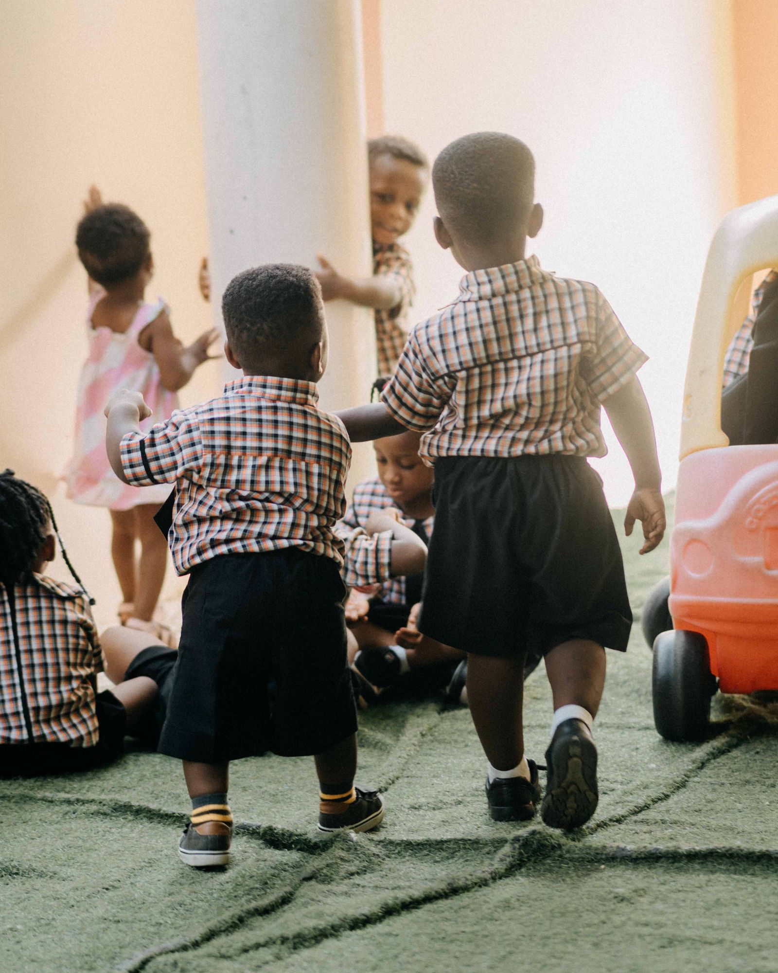 Children playing positively with a teacher in class